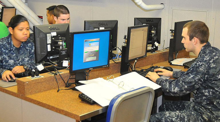 Sailors use computers in the Learning Media Resource Center to check personal email aboard the aircraft carrier USS Carl Vinson.