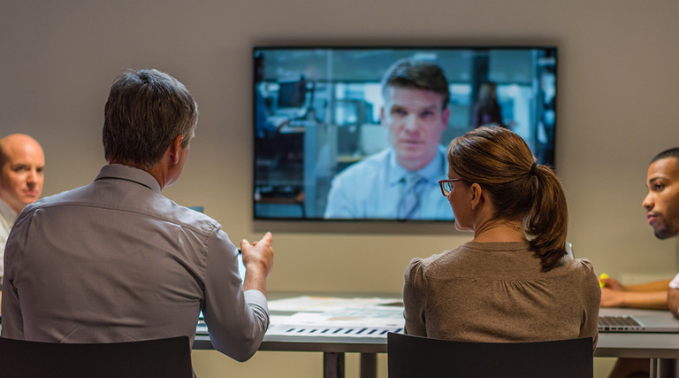Federal workers in a videoconference meeting with a coworker 