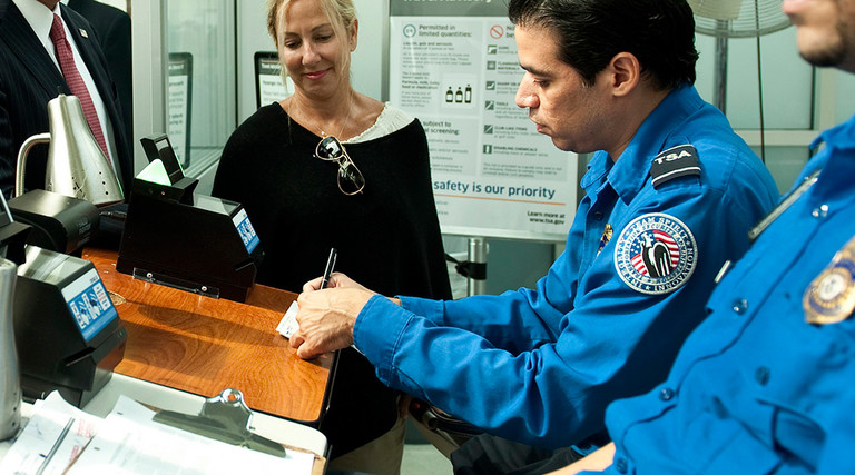 TSA officials checking passenger information