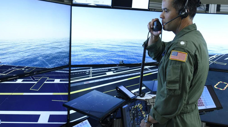 Commander Jason Cassisi, air boss aboard the aircraft carrier USS George H.W. Bush participates in a final prototype demonstration of the Office of Naval Research TechSolutions-sponsored Flight Deck Crew Refresher Training Expansion Packs.