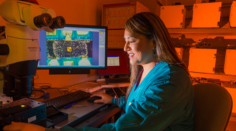 Sandia National Laboratories researcher Rachelle Thompson inspects an electronic device that’s part of a 30-year Sandia program to look at how environments, including radiation from a nuclear weapon itself, could affect the performance of electronics inside a W76-1 warhead. The study, begun in 2006, will provide real-time data for the first time on how electronics age within a weapon.