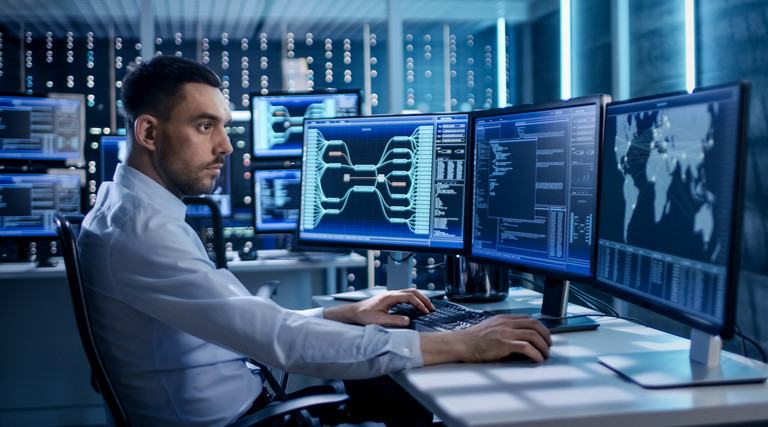 Man monitoring computers