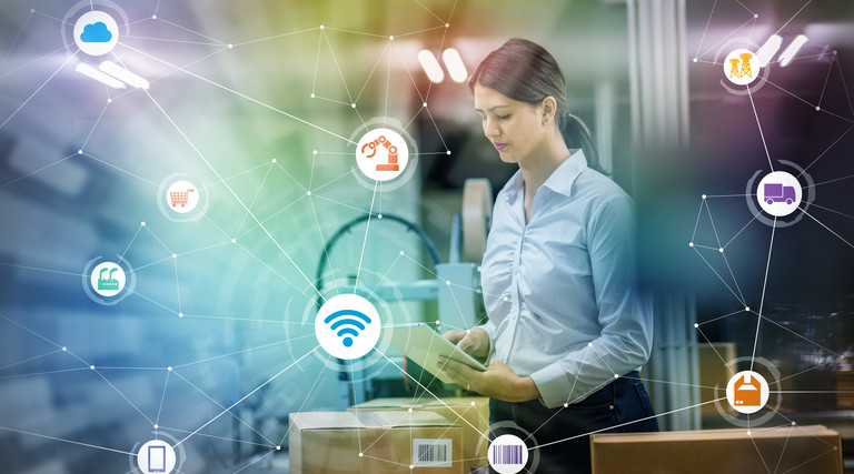 Woman holding tablet under images of network