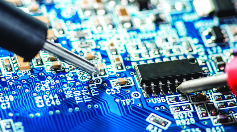 Closeup of screwdrivers working on a computer motherboard