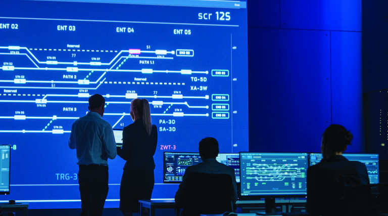 Man and woman in front of screen