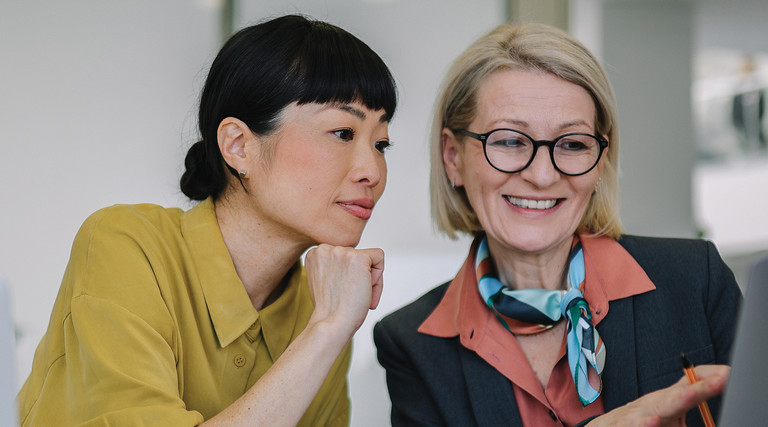 Two coworkers collaborating in the office