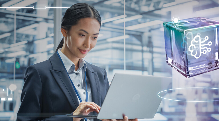 Person using laptop in a data center