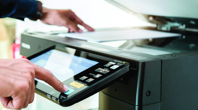 Person using a printer in the office