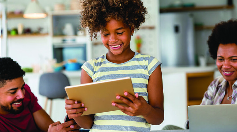 Family with laptop, tablet and smartphone