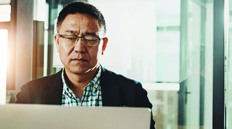 Man submitting information on a laptop