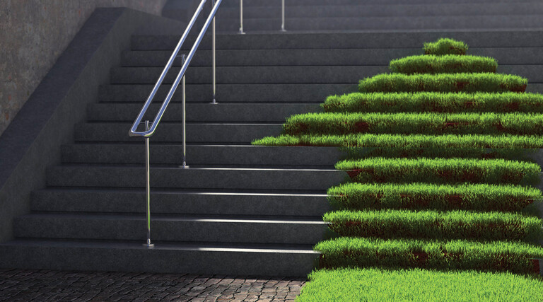 A grassy arrow pointing up concrete stairs