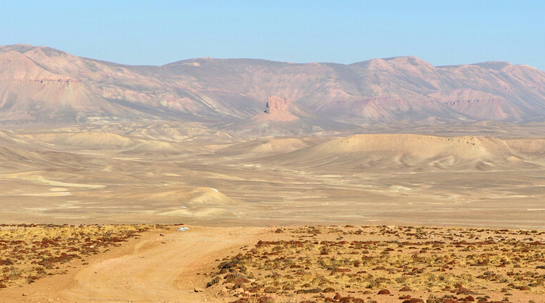 Desert road with mountains