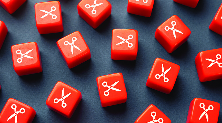 Orange dice with scissors printed on them