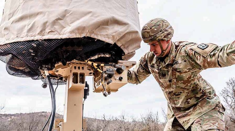 Military member using tech in the field