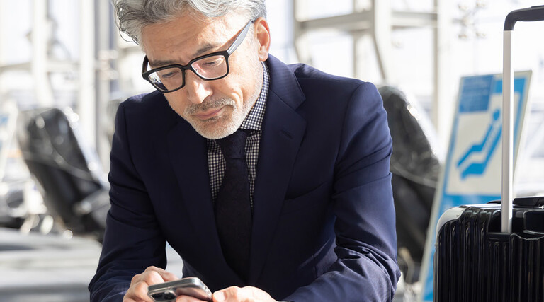Person using mobile device in airport