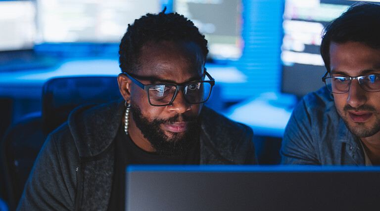 Two men looking at computer screen