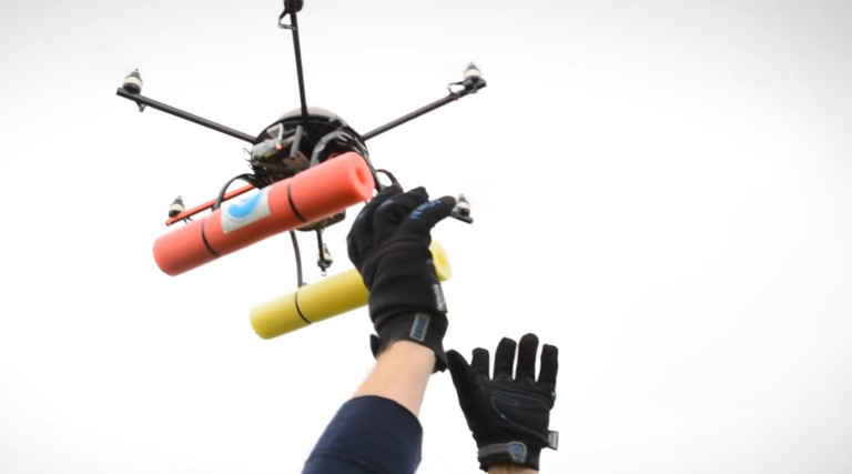 hands lifting a drone into the air