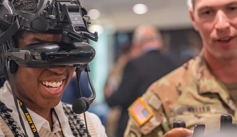 Army intern tries on a virtual reality headset
