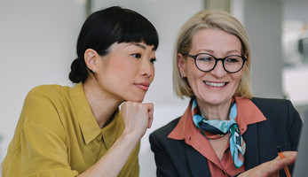 Two coworkers collaborating in the office