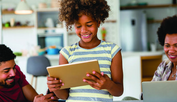 Family with laptop, tablet and smartphone