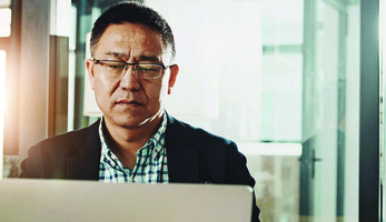 Man submitting information on a laptop