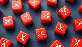 Orange dice with scissors printed on them