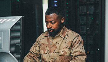 Soldier working on computer