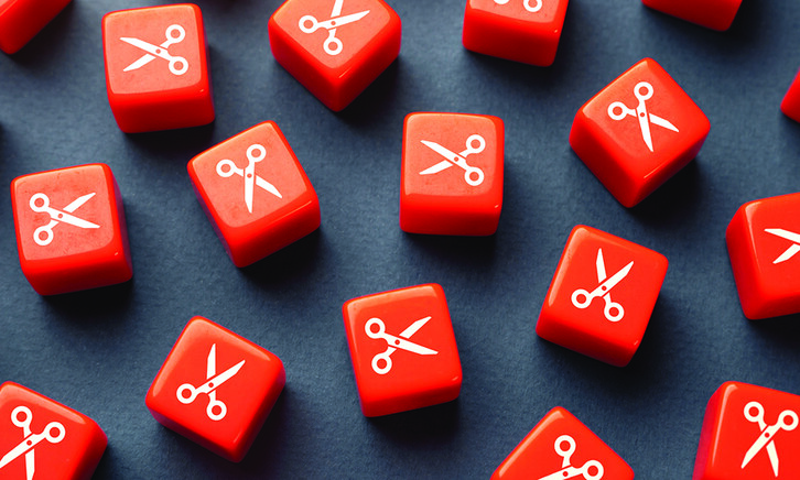 Orange dice with scissors printed on them