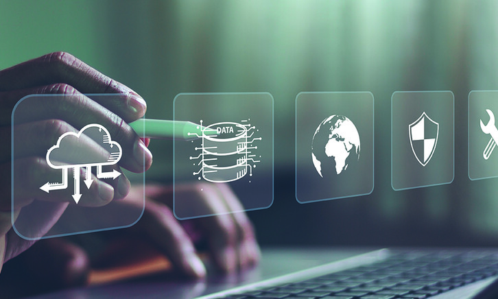 Person using a laptop with a disaster recovery icon on a virtual screen