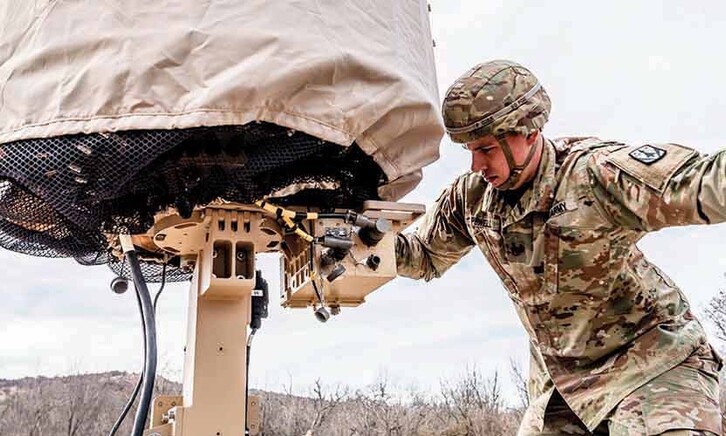Military member using tech in the field
