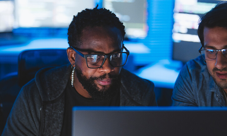 Two men looking at computer screen