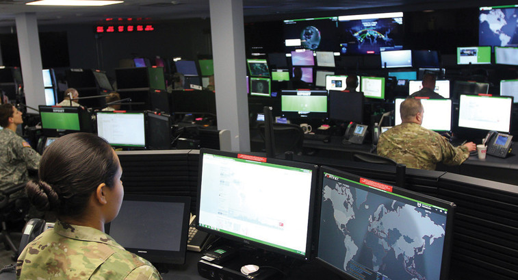 Sgt. Marisa Tortolano, a cyber operations specialist assigned to the 780th Military Intelligence Brigade, stands in the watch officer position of the Joint Mission Operations Center.