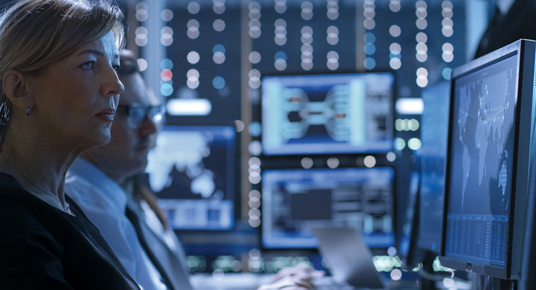 women watches monitor in mission-critical center