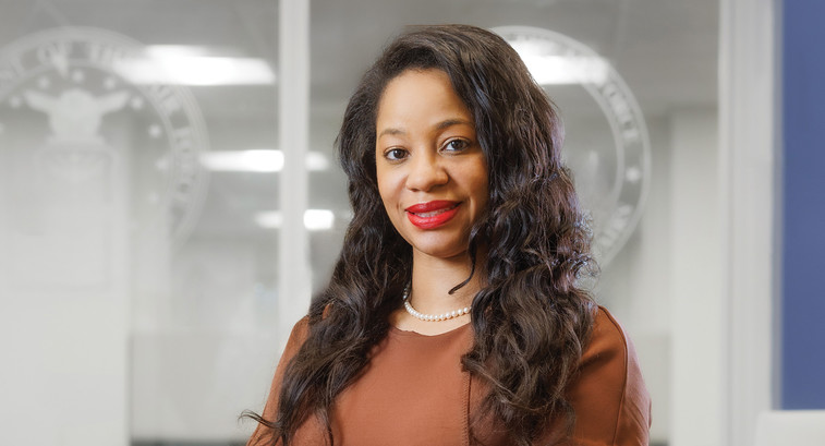 Woman in front of govt glass doors