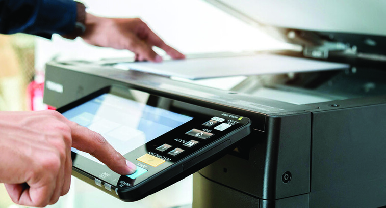 Person using a printer in the office