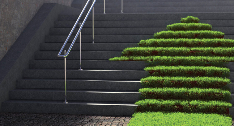 A grassy arrow pointing up concrete stairs