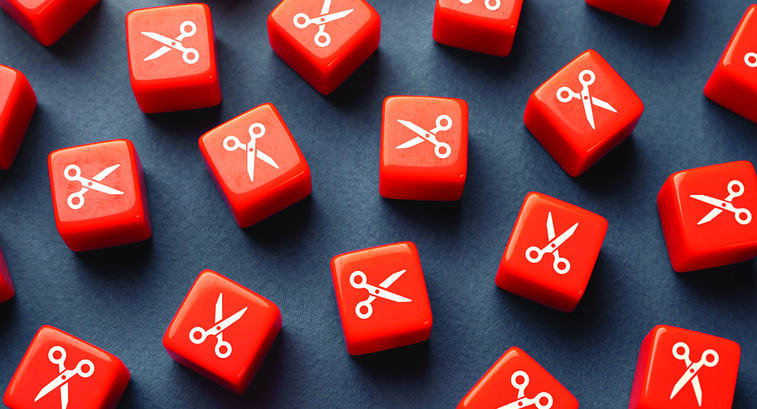 Orange dice with scissors printed on them