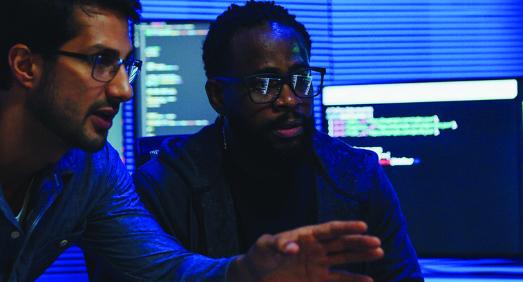 two male coworkers working in tech office