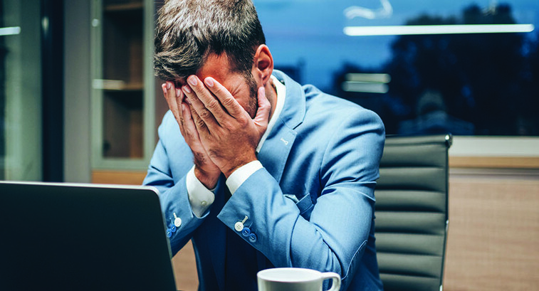 Employee with head in hands