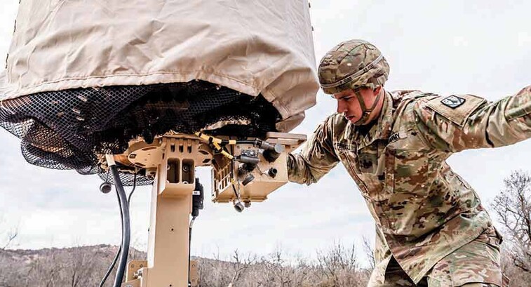 Military member using tech in the field
