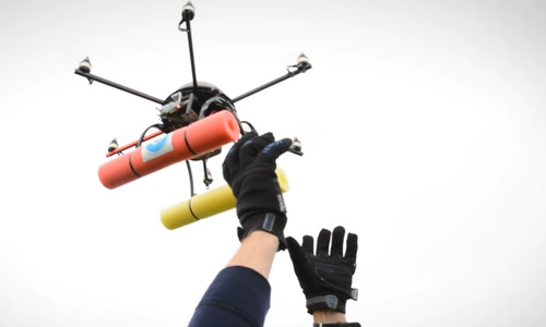 hands lifting a drone into the air