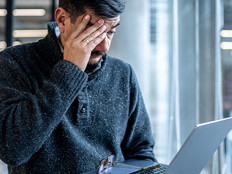 Worried man looking at his laptop in the office