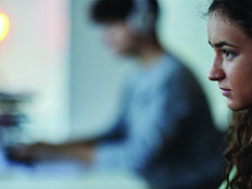 Woman at a monitor with headphones