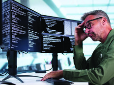 Man looking at coding on computer