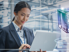 Person using laptop in a data center