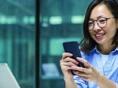 Person using smartphone at desk