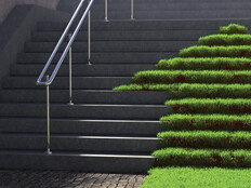 A grassy arrow pointing up concrete stairs