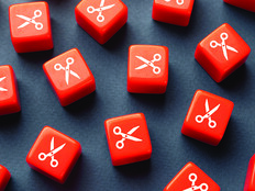 Orange dice with scissors printed on them