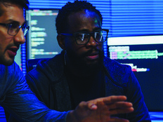 two male coworkers working in tech office