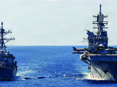 The USS Rafael Peralta (left) steams alongside the USS Tripoli